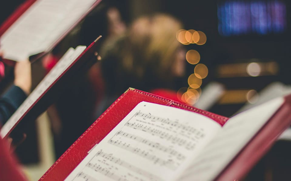 A singer holding an open music score