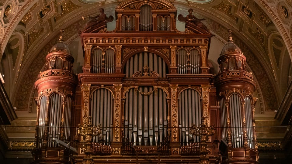 An ornate pipe organ in a church